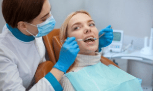 Dentist examining patient's teeth during dental visit in Melissa, TX office.