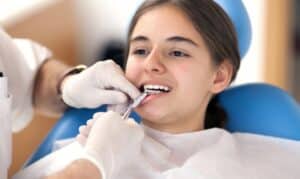 Young patient receiving dental bonding treatment in dental chair at Melissa, TX practice.
