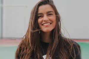 Young woman smiling, demonstrating a bright, healthy smile for dental care.